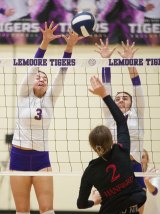 Lemoore's Ava Cunningham and Nataliha Johnson go high against Bullpups as Tigers beat Hanford 3-0 in WYL action.